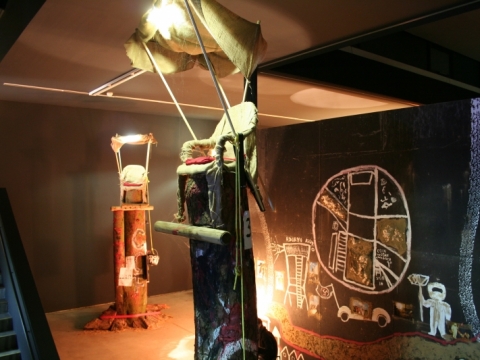 Christoph Schlingensief, intervencijos „Baimės bažnyčia. Pirmasis sėdėjimo ant kuolo konkursas“ 50-ojoje Venecijos bienalėje fragmentas. 2003 m.