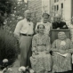 Prie namo Šv. Zitos g. Panevėžyje. Iš kairės: (stovi) Pranas Viržonis, Elena Viržonytė, kunigas Antanas Gobis, Konstancija Viržonytė, (sėdi) Marija Galiauskaitė, Gabrielė Petkevičaitė-Bitė, Elžbieta Viržonienė ir Juozas Viržonis. Apie 1939 m. R. Viržonytės ir R. Aleknaitė-Bieliauskienės archyvo nuotr.